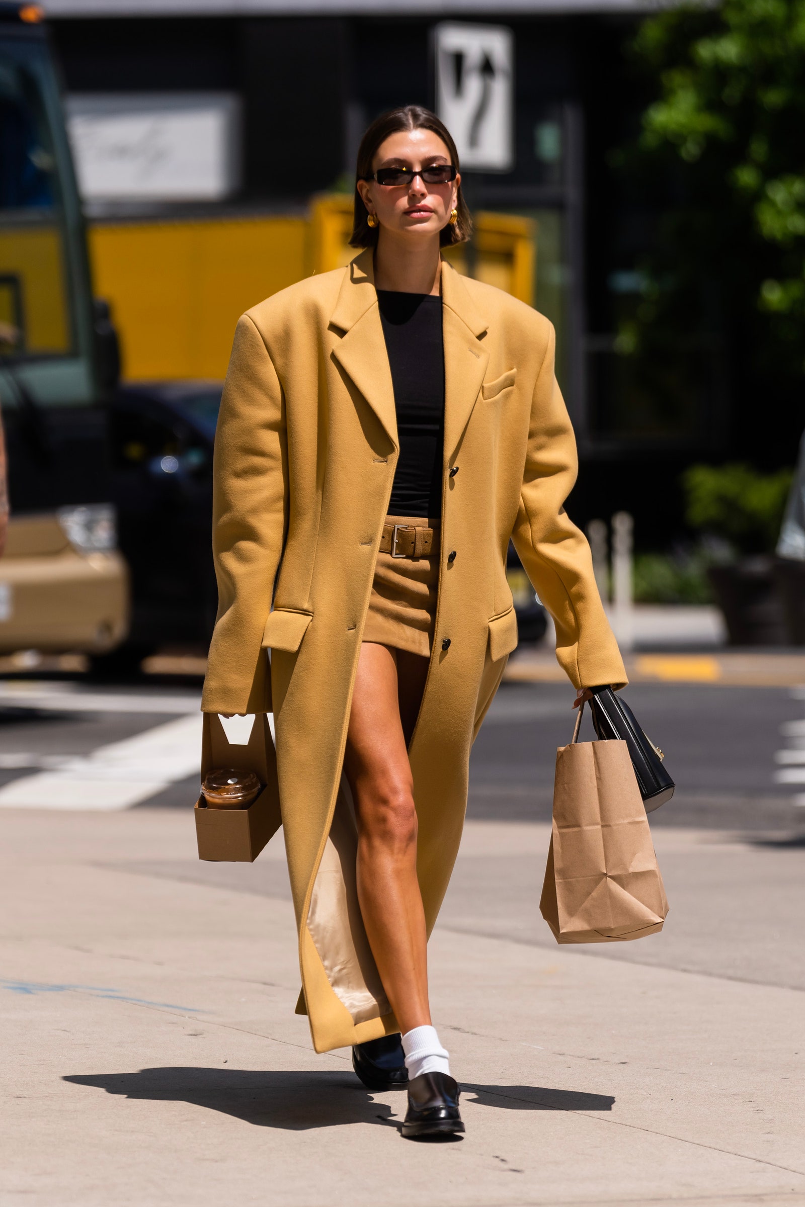 Image may contain Hailey Baldwin Clothing Coat Accessories Bag Handbag Footwear Shoe Pedestrian Person and Glasses