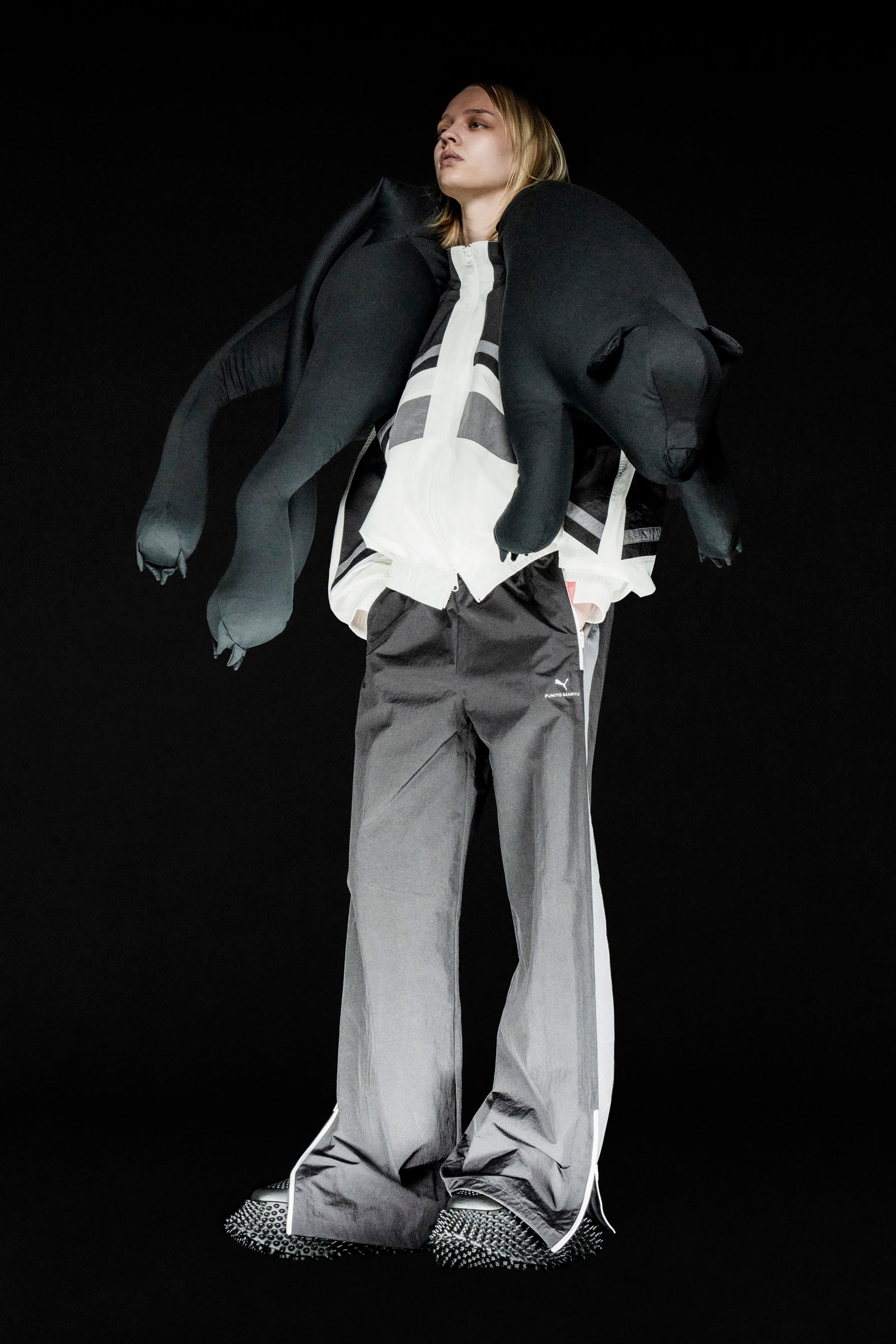 Image may contain Clothing Pants Blazer Coat Jacket Adult Person Footwear Shoe Formal Wear Accessories and Tie