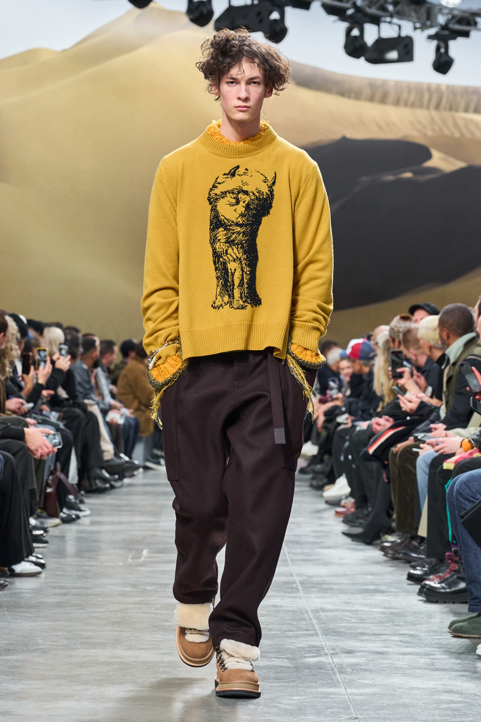 Image may contain Clothing Pants Footwear Shoe Adult Person Teen Sleeve Knitwear Sweater Long Sleeve and Hat