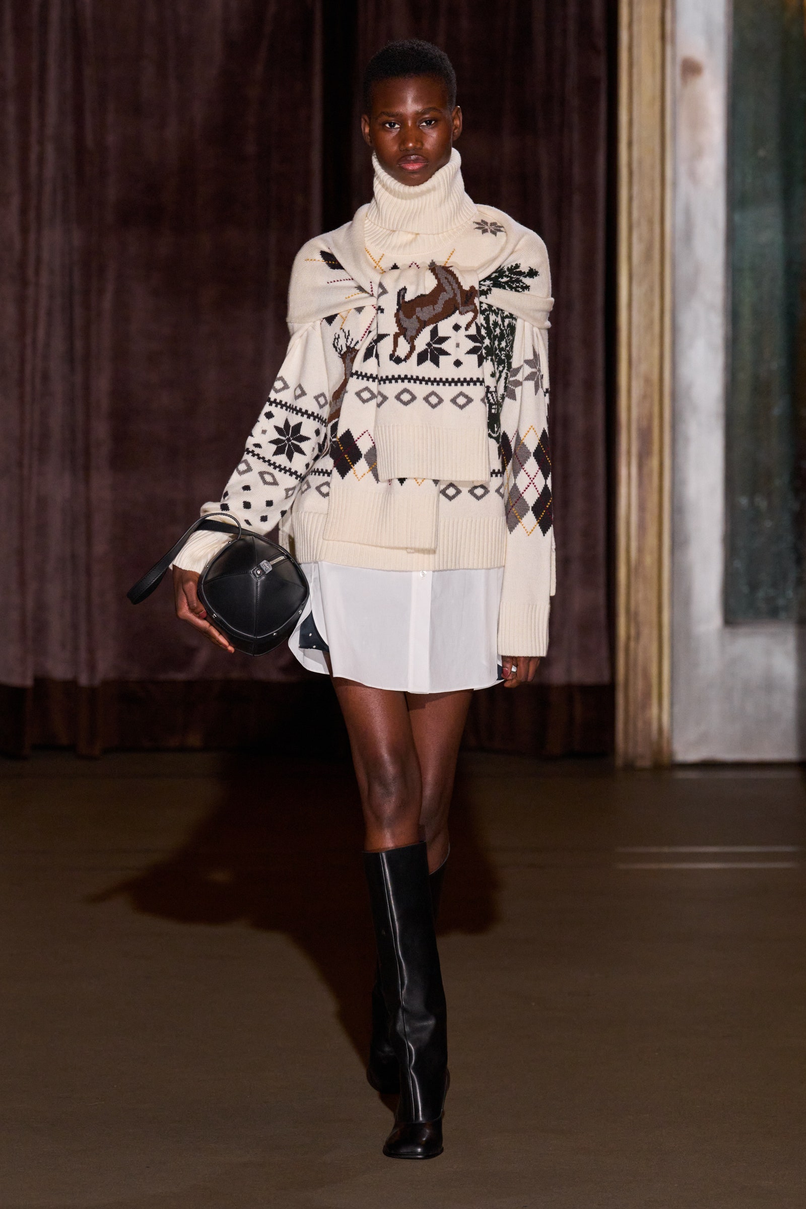 Image may contain Adult Person Fashion Clothing Footwear Shoe Skirt Coat Long Sleeve Sleeve Accessories and Bag