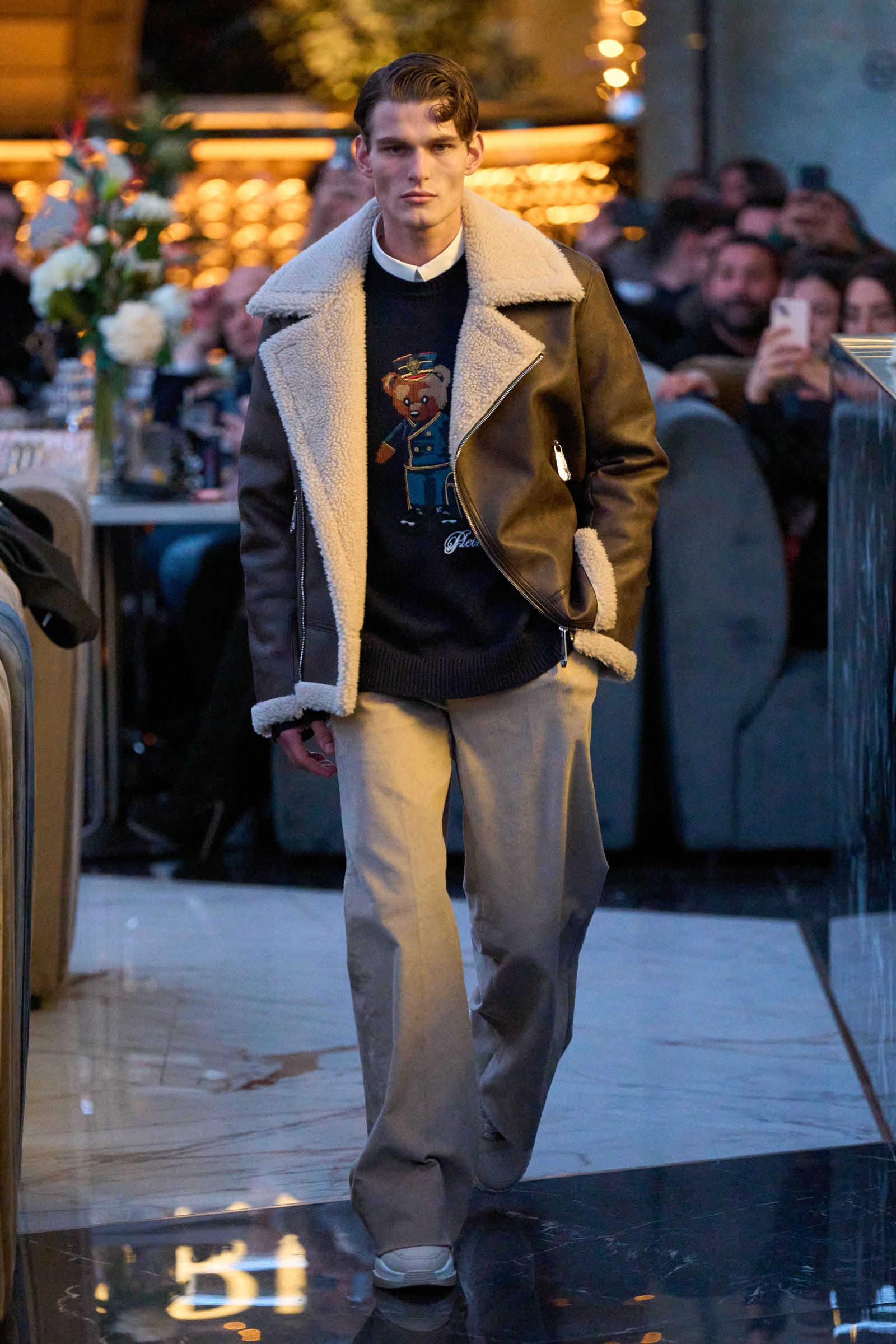 Image may contain Oliver Cheshire Clothing Coat Person Standing Adult Jacket Footwear Shoe and Electronics