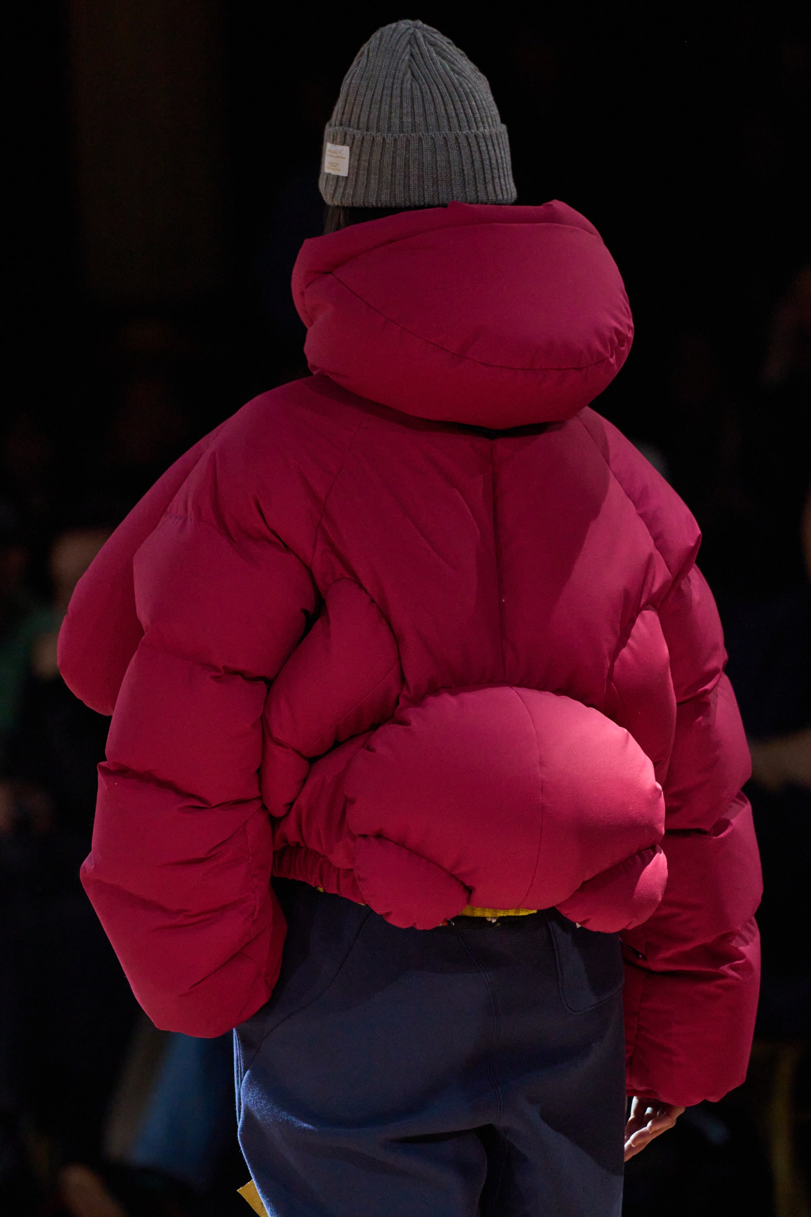 Image may contain Clothing Coat Jacket Hood Baby Person Glove Hat and Cap
