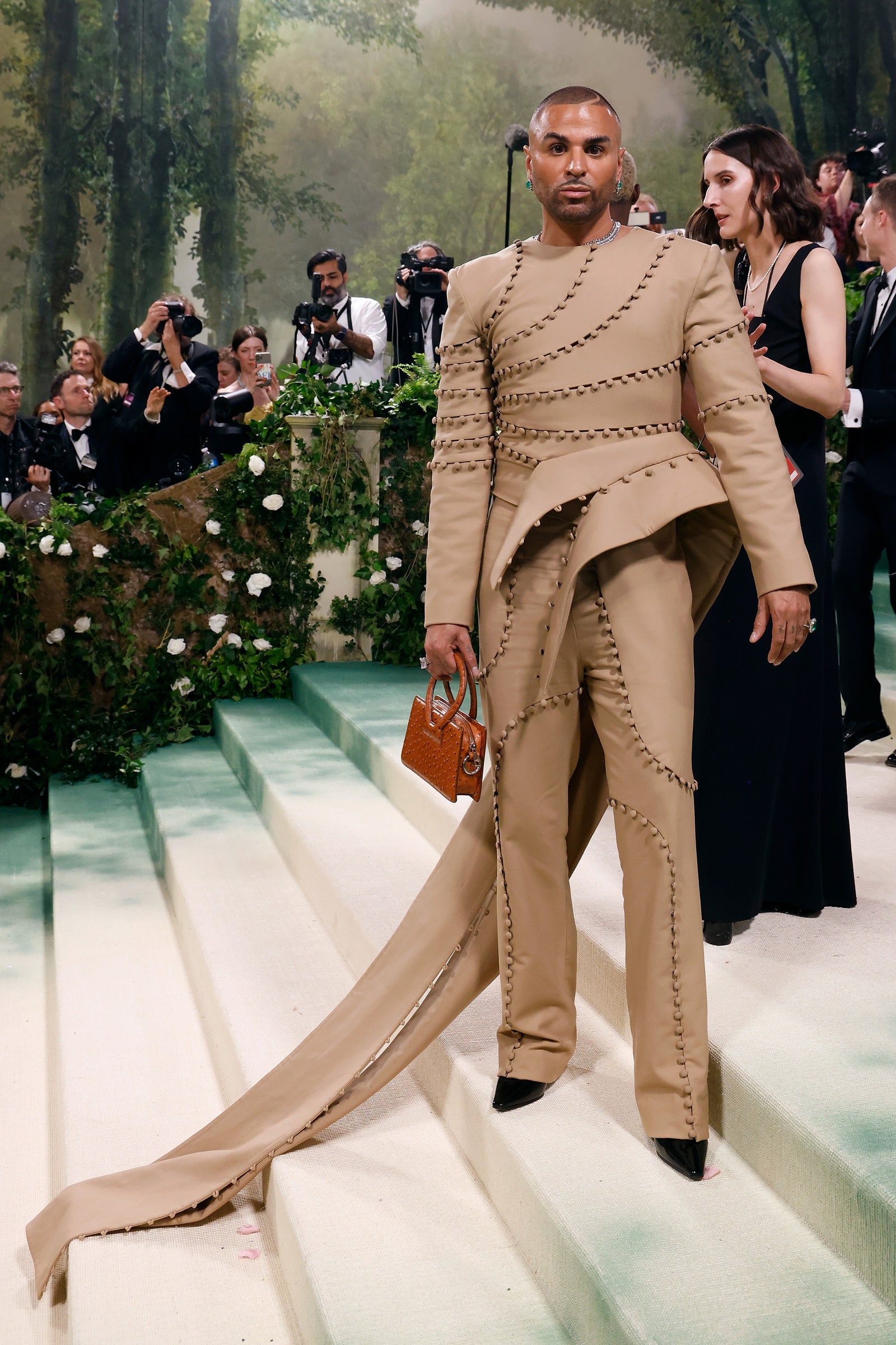 Image may contain Jacqui Abbott Person Adult Clothing Formal Wear Suit Footwear Shoe Accessories Tie and Jewelry
