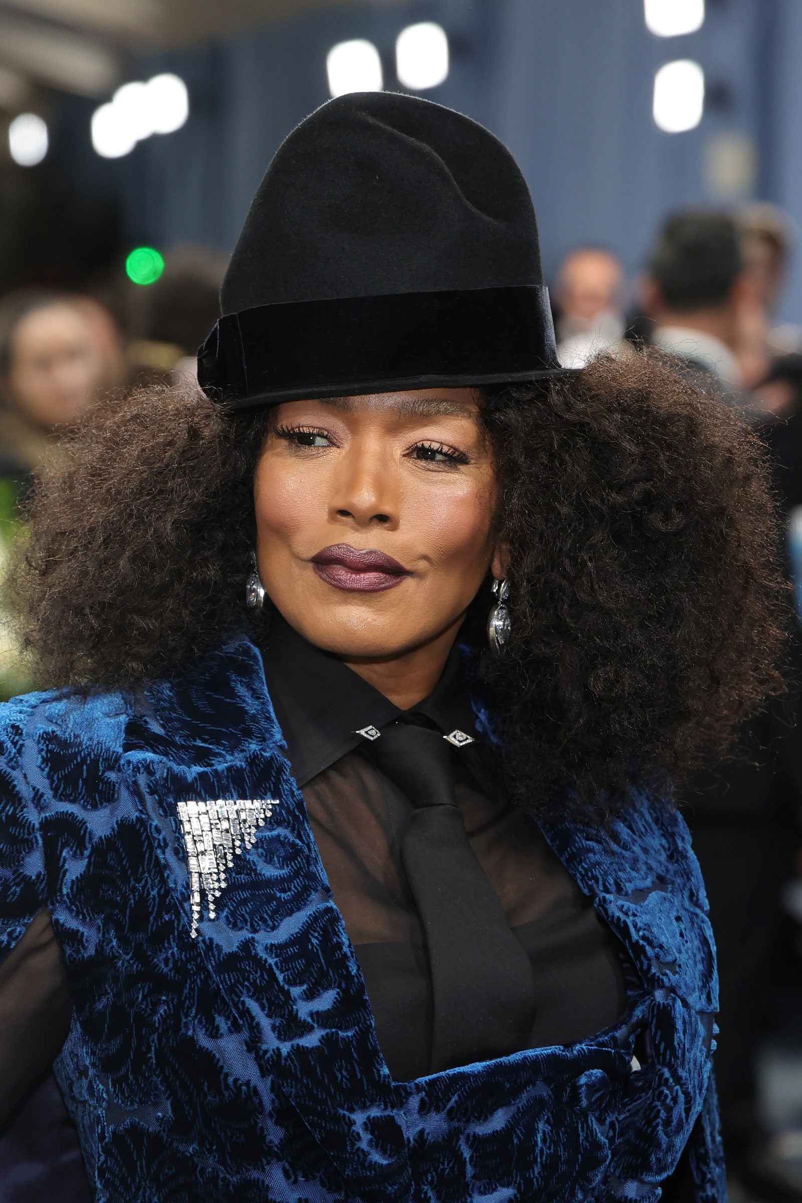 Image may contain Angela Bassett Clothing Hat Accessories Formal Wear Tie Adult Person Black Hair Hair and Face