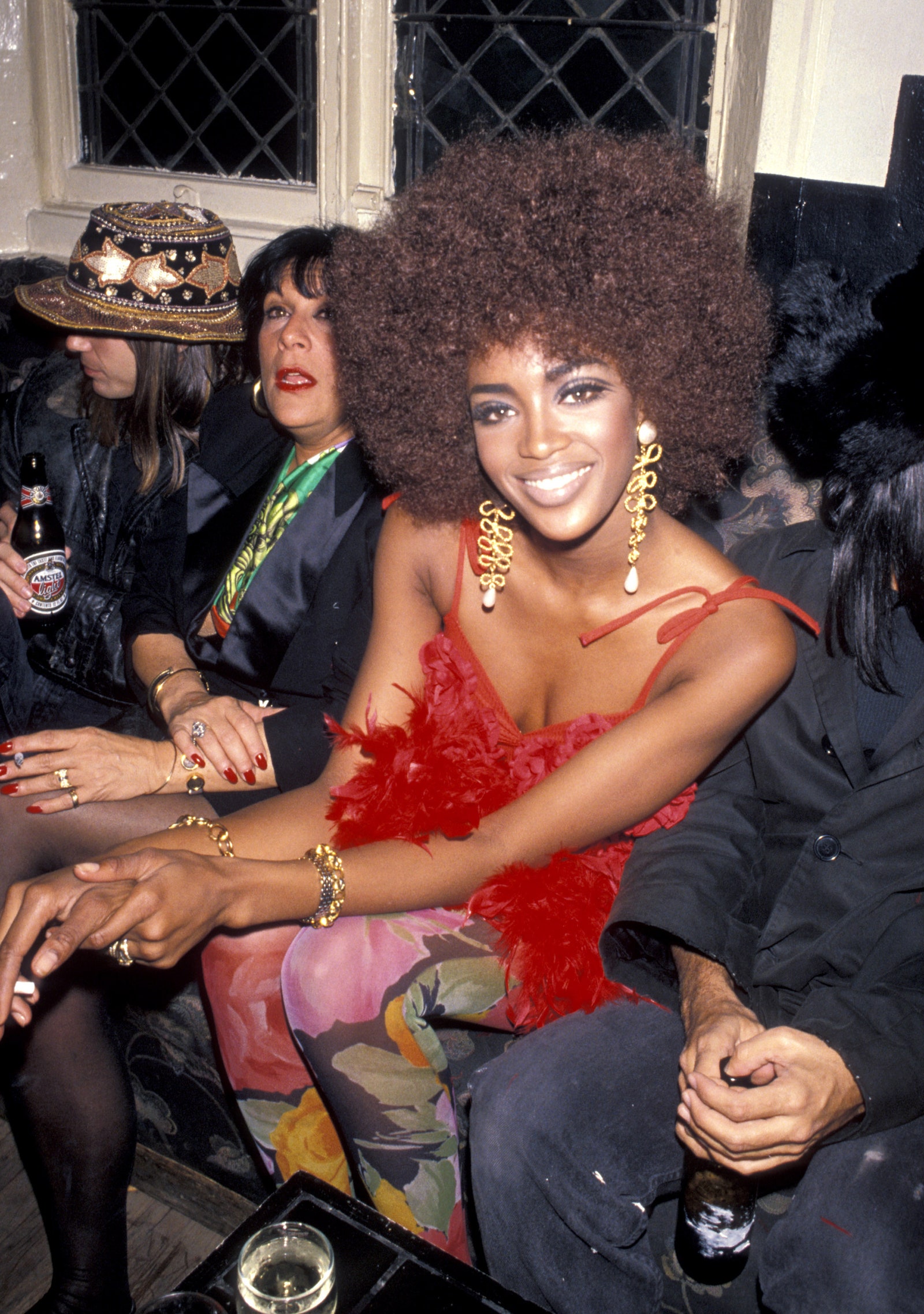 Image may contain Naomi Campbell Clothing Hat Adult Person Accessories Jewelry Ring Cup Bracelet Face and Head