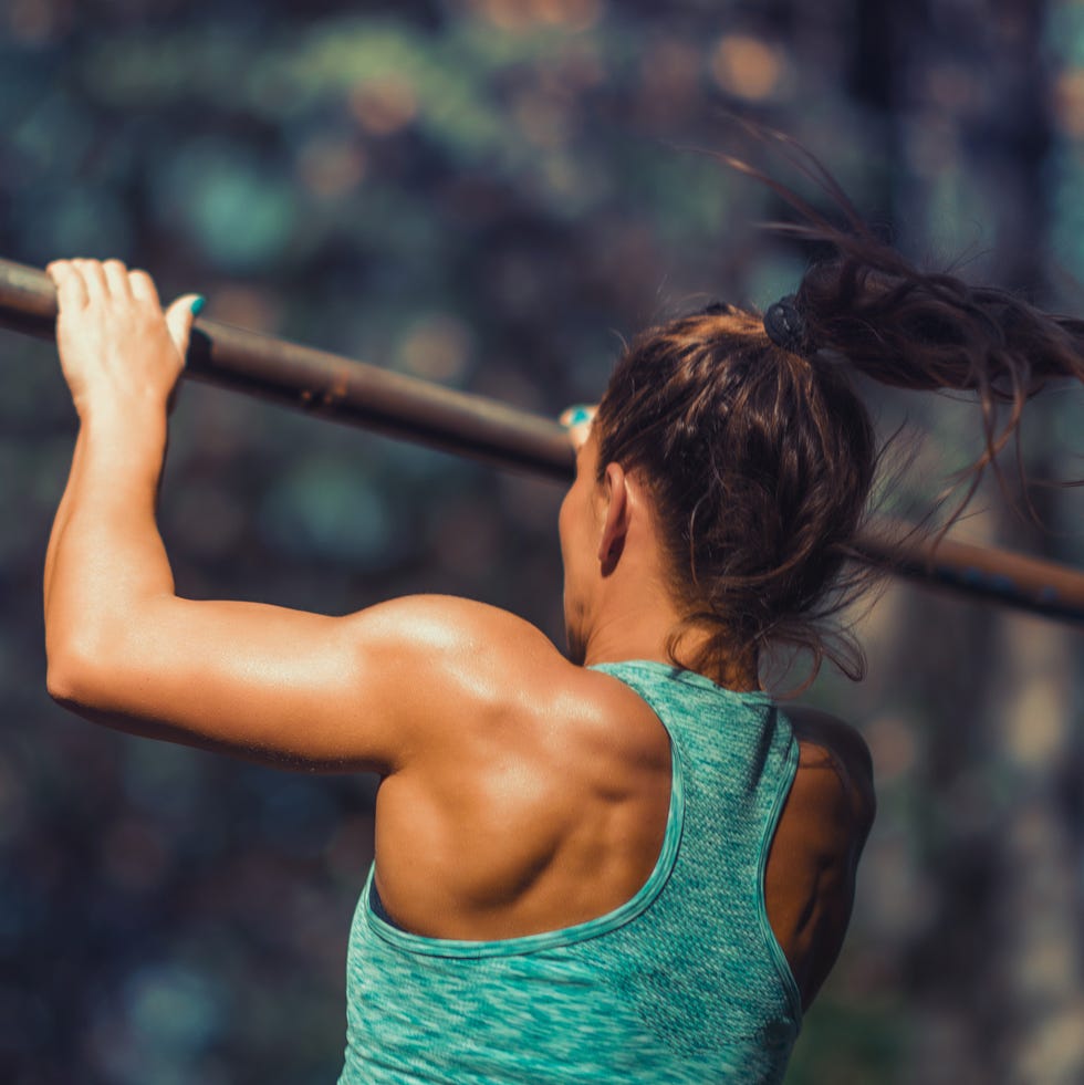 female athlete exercising at park during autumn