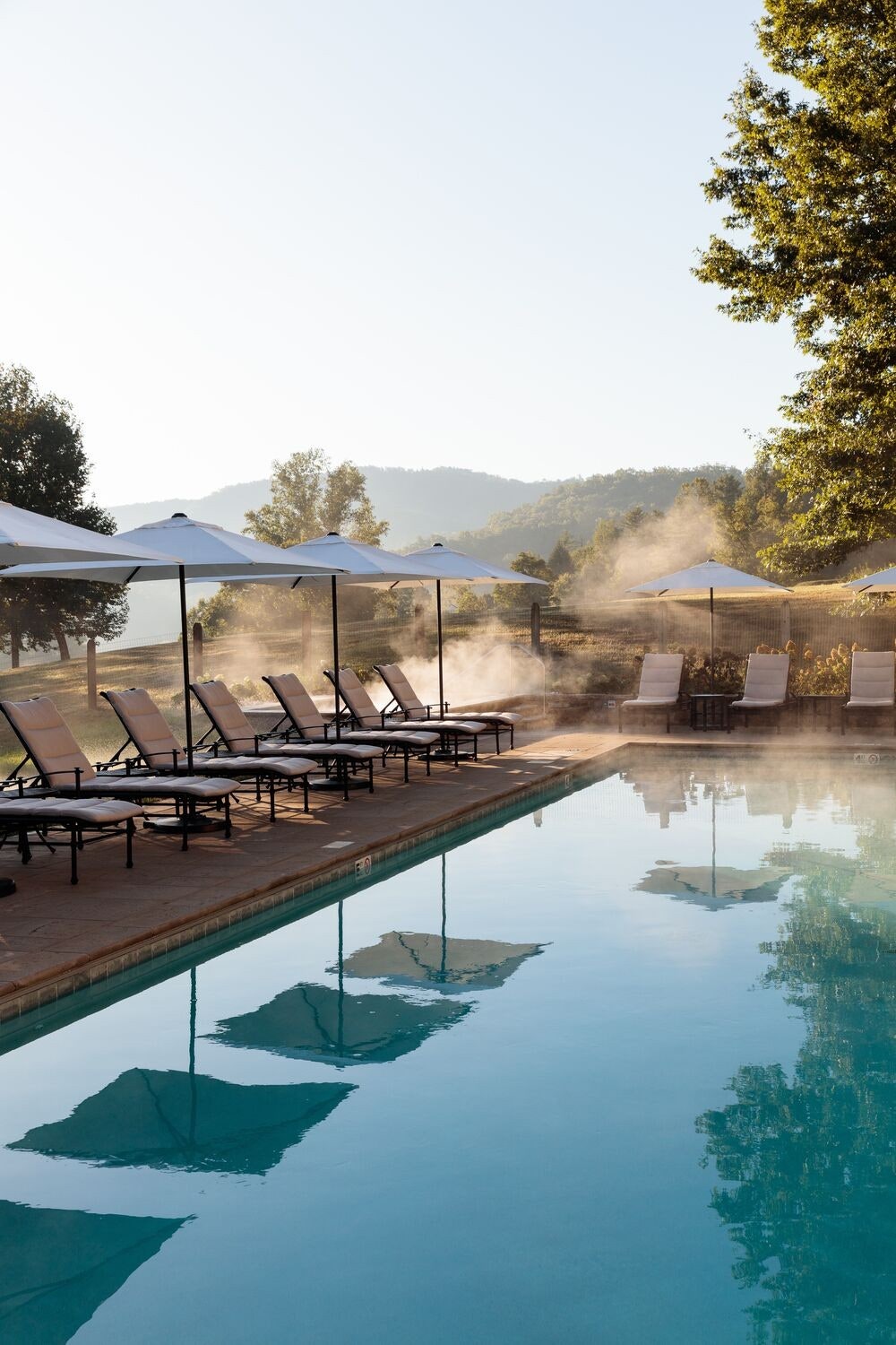 Image may contain Architecture Building Hotel Resort Chair Furniture Pool Water Nature Outdoors and Scenery