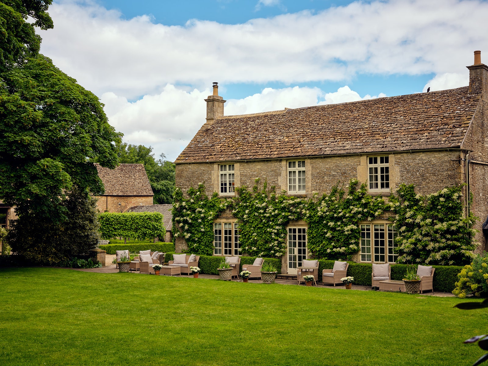 Image may contain Architecture Building Housing Chair Furniture Plant House Manor and Grass