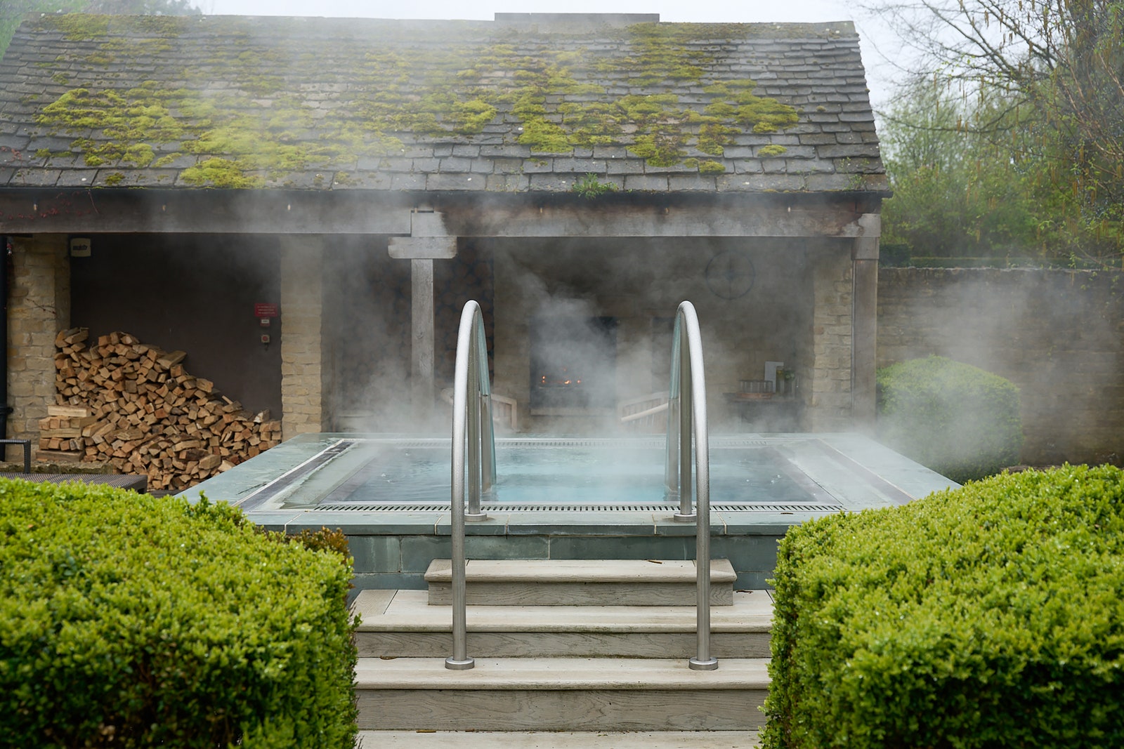 Image may contain Tub Fence Hedge Plant Hot Tub Bathing Pool and Water