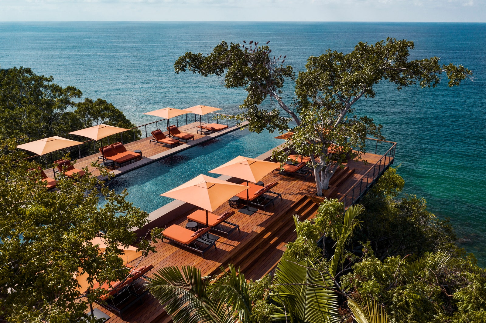 Image may contain Outdoors Pool Water Swimming Pool Chair Furniture Nature Sea and Aerial View