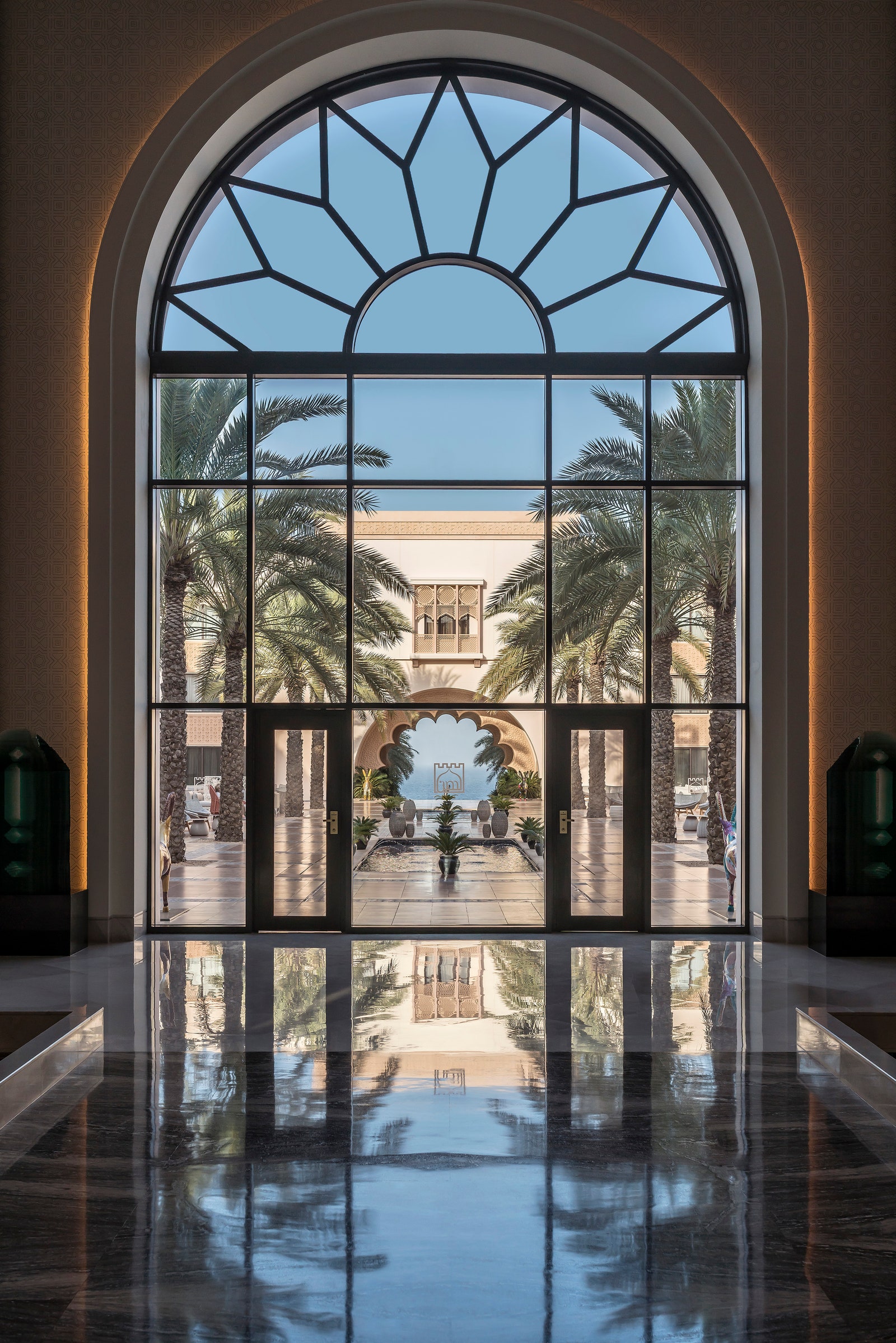 Image may contain Floor Flooring French Window Window Arch Architecture Plant and Person