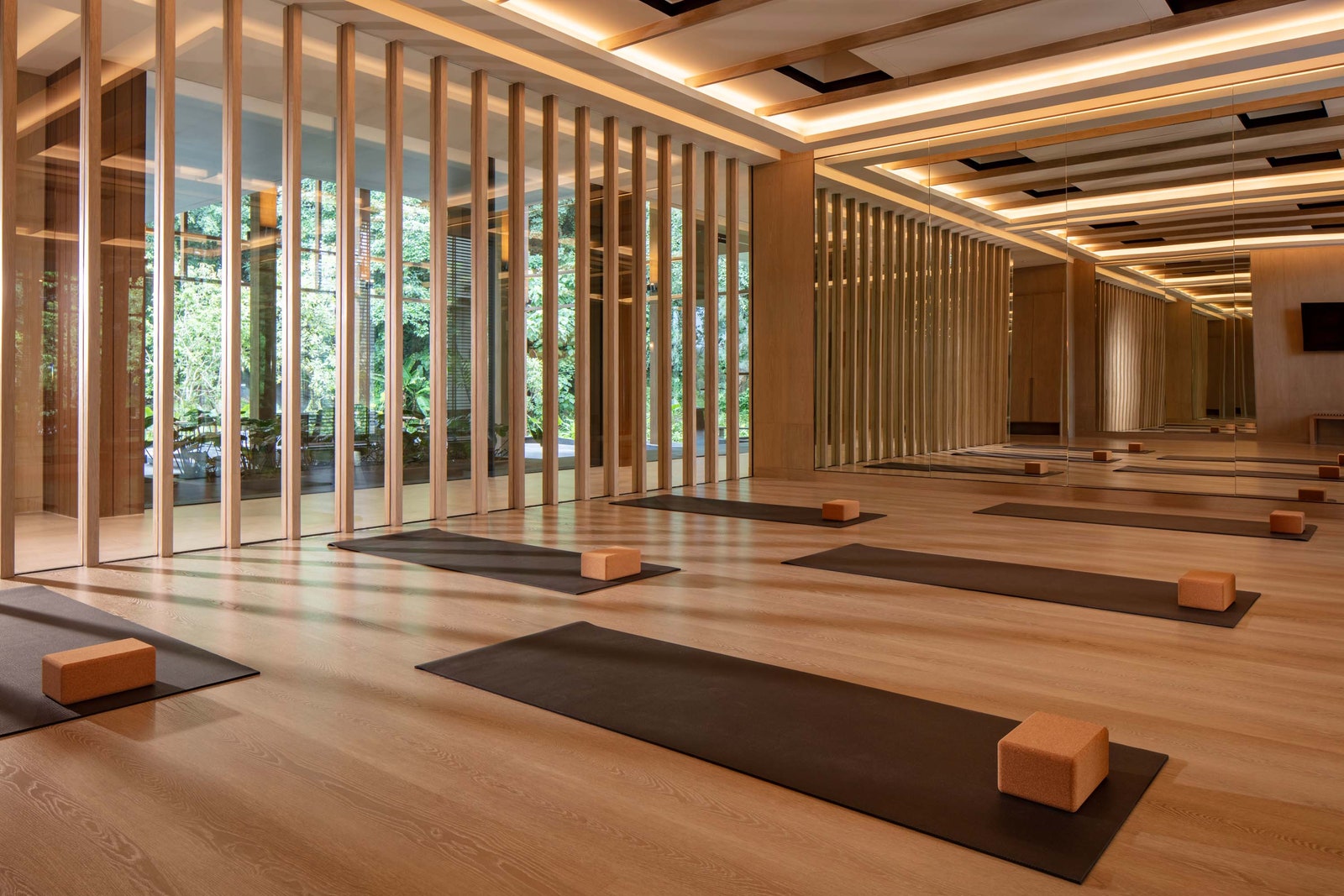 Image may contain Indoors Interior Design Floor Fitness Pilates Sport Working Out Wood and Computer Hardware